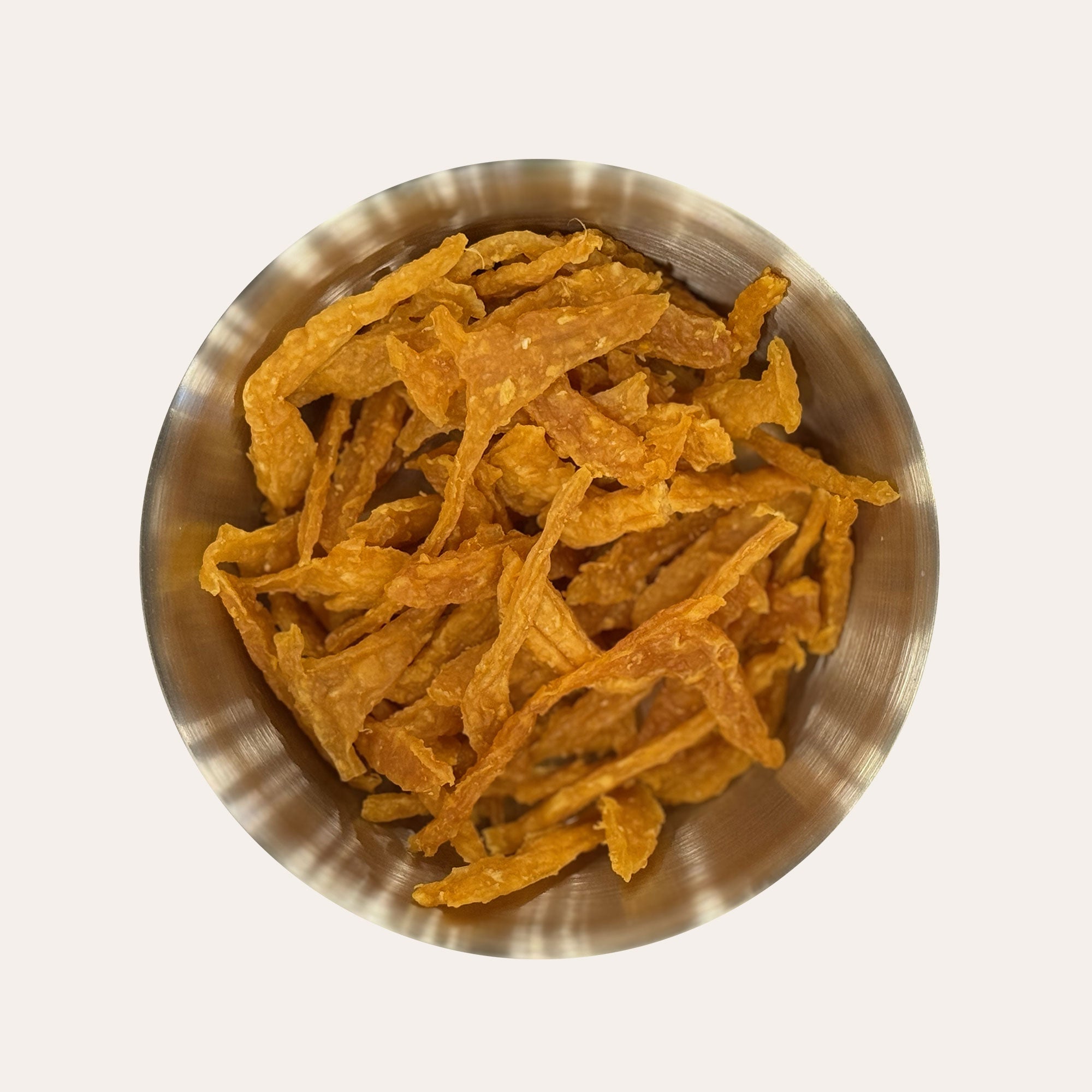 Metal bowl filled with Ernie's Positively Good Chicken Jerky In Fun Golf Shapes dog treats.