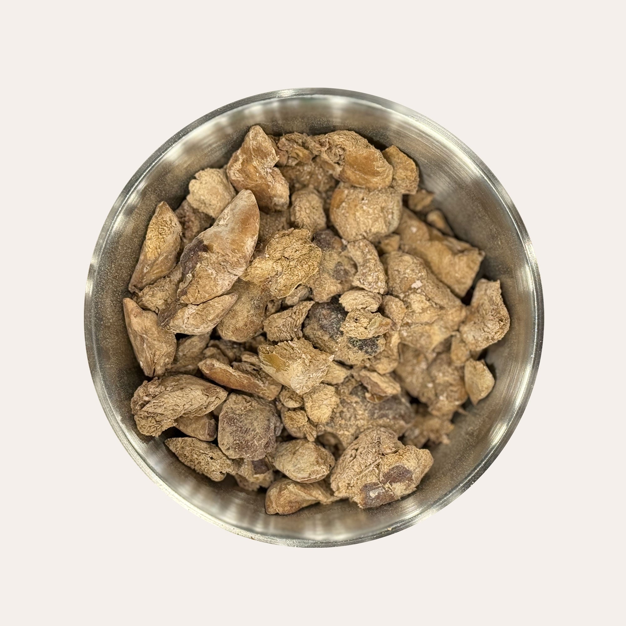 Metal bowl filled with Ernie's Positively Good freeze-dried chicken liver dog treats.