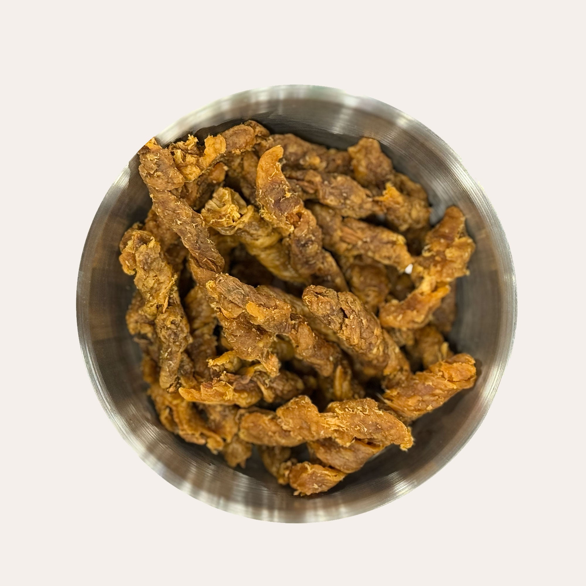 Metal bowl filled with Ernie's Positively Good Chicken Wrapped Sweet Potato Recipe dog treats.